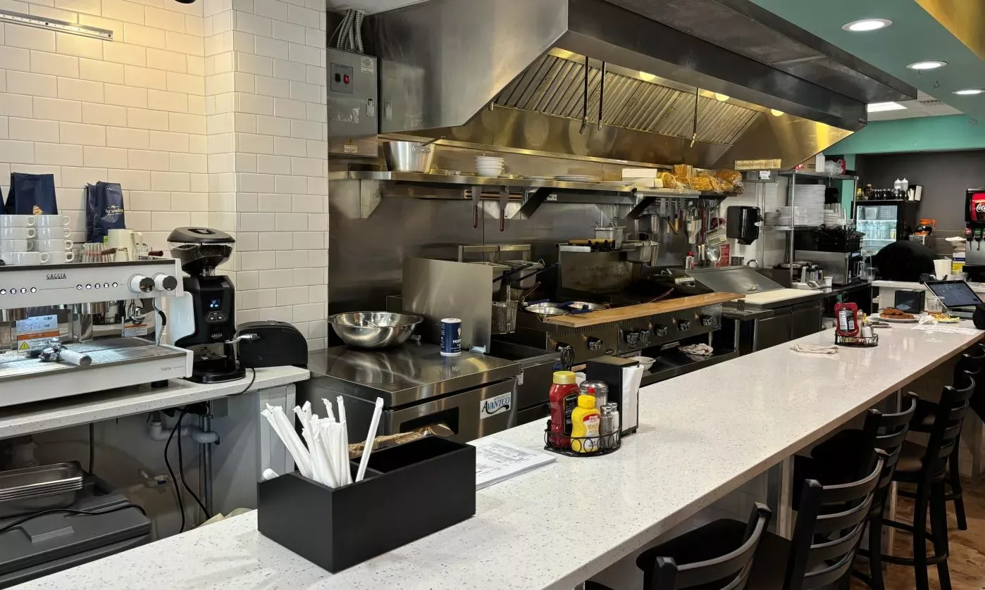 The counter at Nadine's Cafe, with the espresso machine and the grill behind it
