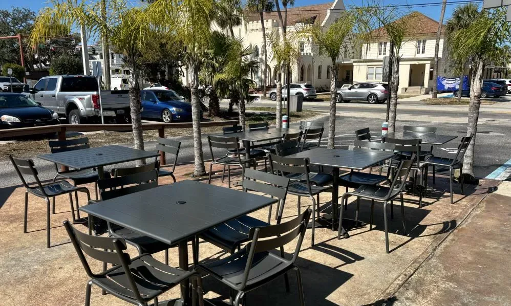 Patio tables under palm trees