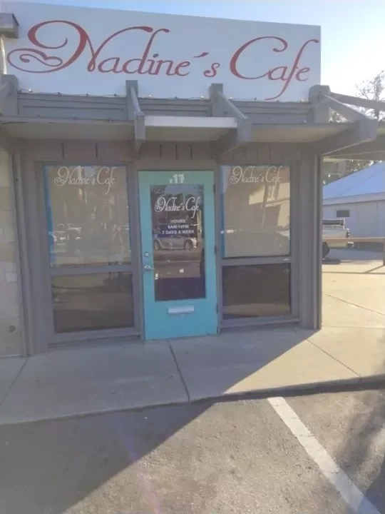 The front of Nadine's Cafe with its teal door